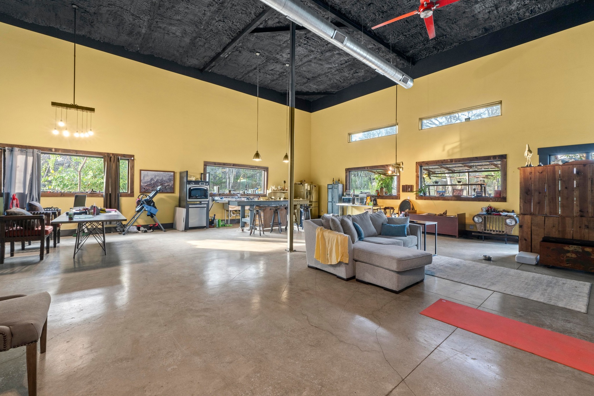 12302 Bethel Church Road Manchaca, TX 78652 - Photo 7 of 35 a living room with furniture a flat screen tv and a floor to ceiling window