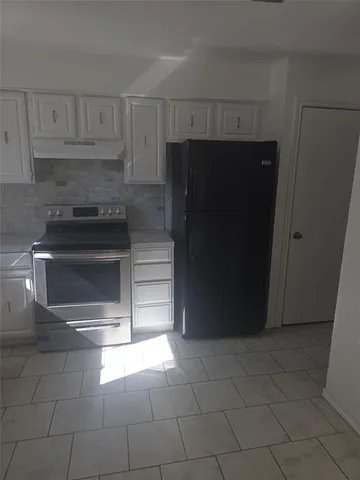 a kitchen with a refrigerator and a cabinets
