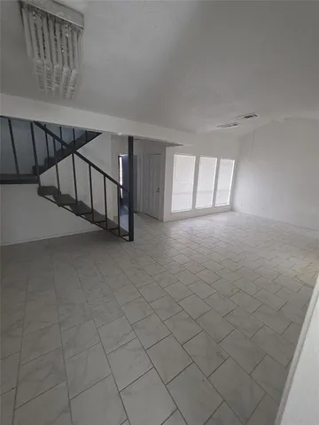 a view of an empty room with windows