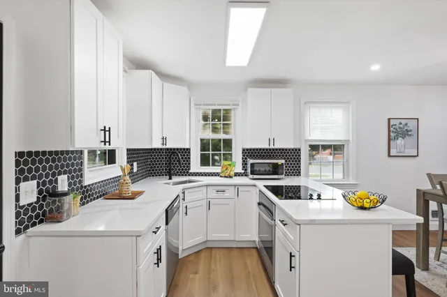 a kitchen that has a sink and a stove in it