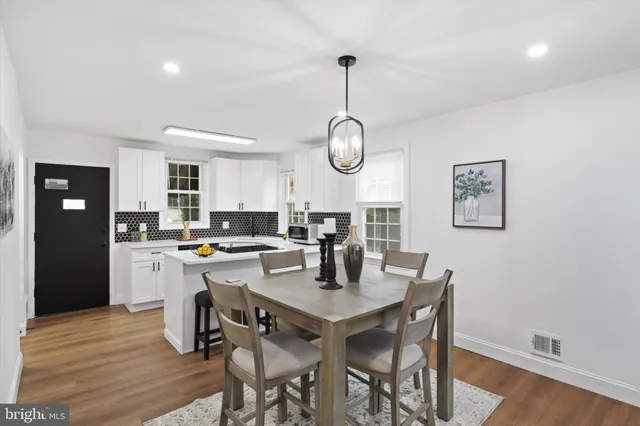 a view of a dining room with furniture wooden floor and chandelier