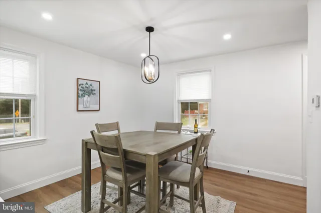 a view of a dining room with a table and chairs