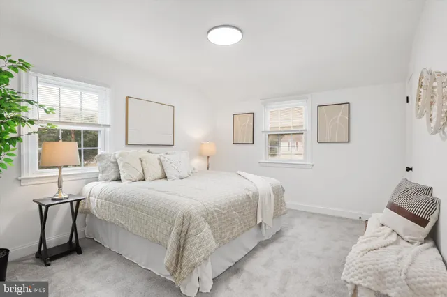 a bedroom with a bed and a lamp