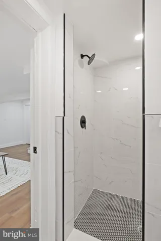 a bathroom with a granite countertop shower
