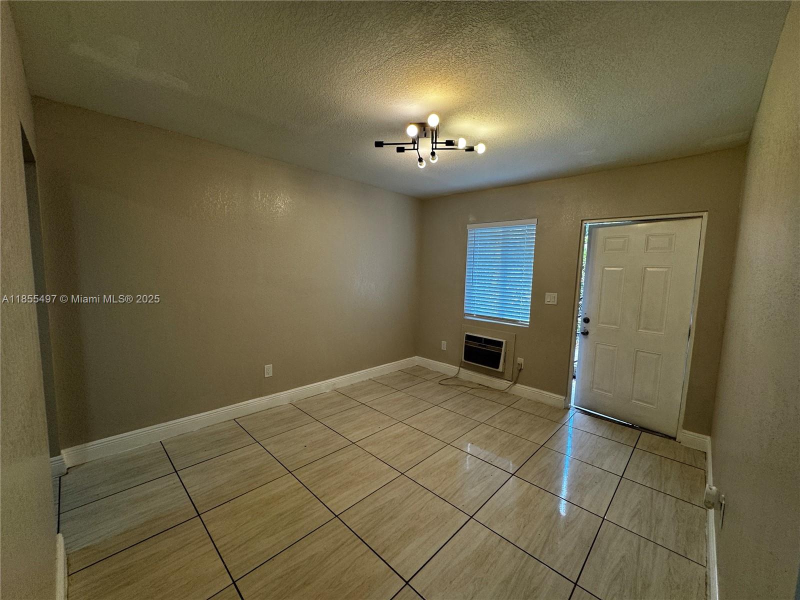 1940 Washington Avenue, Unit 12 Opa-Locka, FL 33054 - Photo 5 of 13 an empty room with a bathroom
