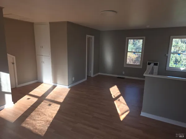 a workspace with wooden floor and windows