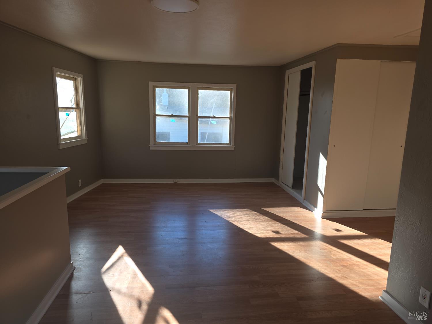 420 Howell Mountain Road Angwin, CA 94508 - Photo 3 of 3 a view of an empty room with wooden floor and a window