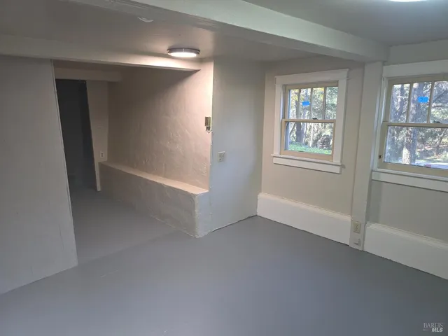 an empty room with windows and closet