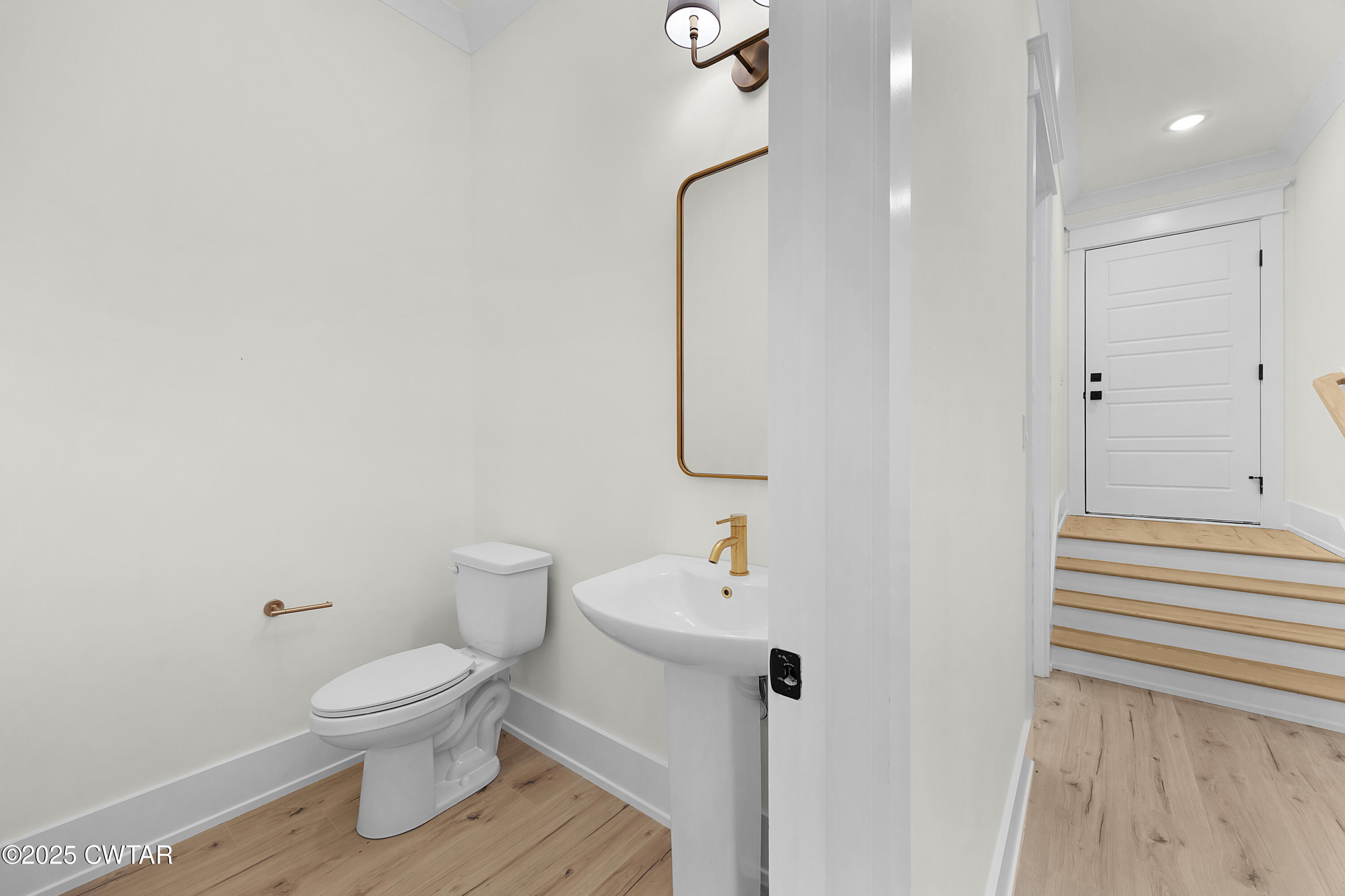 219 Clay Street Jackson, TN 38301 - Photo 15 of 25 a white toilet sitting next to a bathroom sink