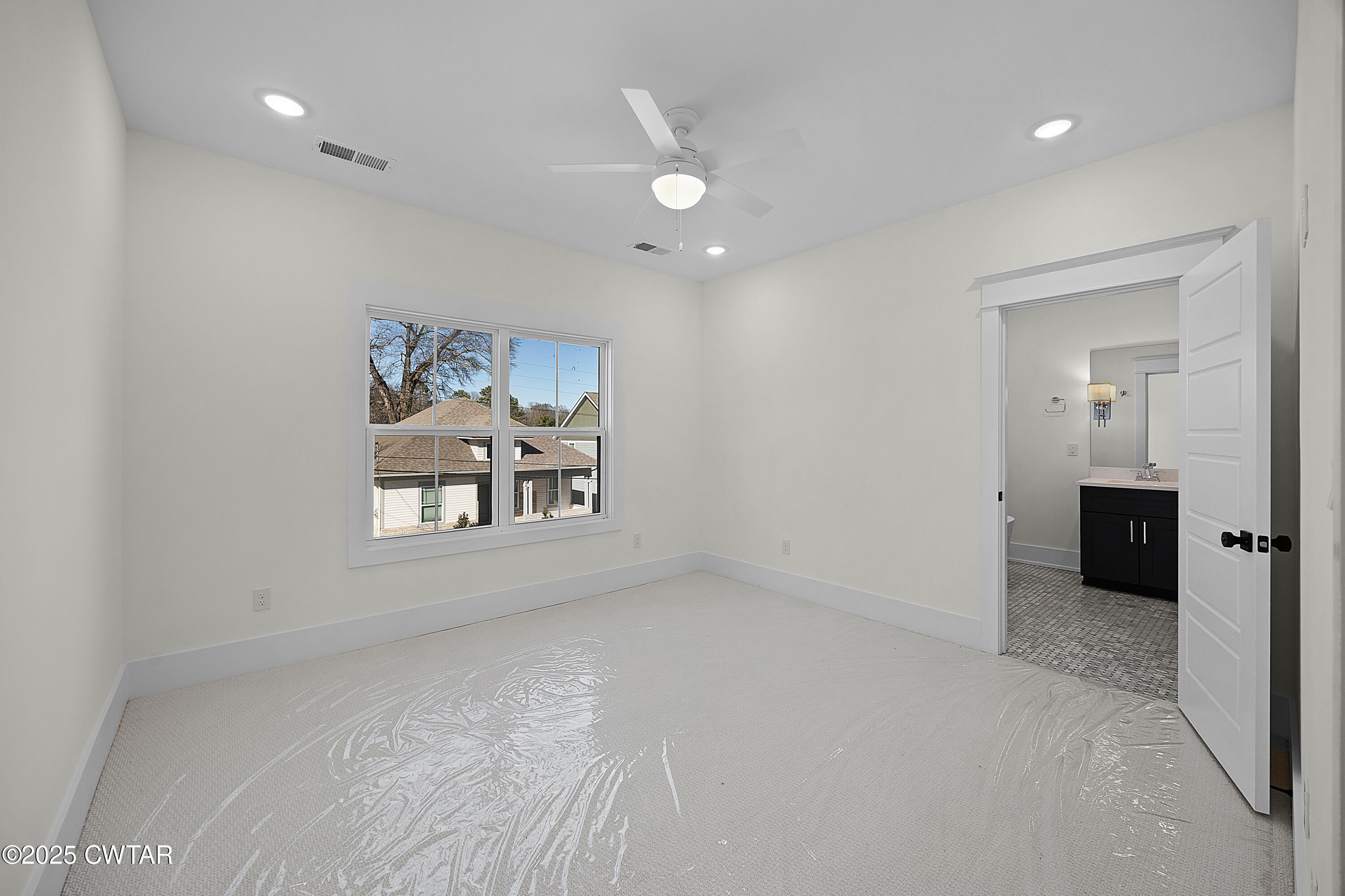 219 Clay Street Jackson, TN 38301 - Photo 17 of 25 an empty room with windows and cabinet