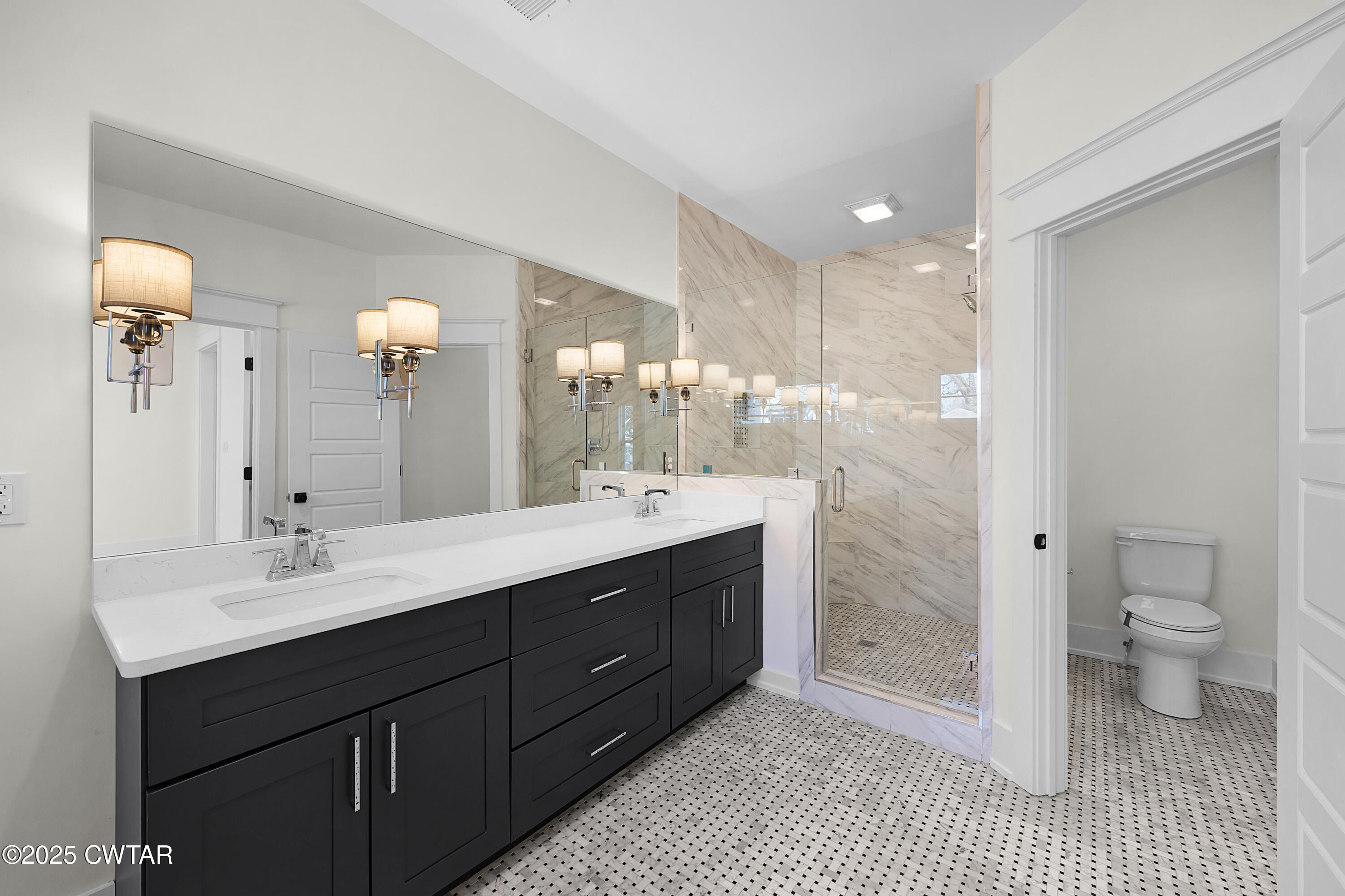 219 Clay Street Jackson, TN 38301 - Photo 18 of 25 a spacious bathroom with a double vanity sink toilet mirror and shower