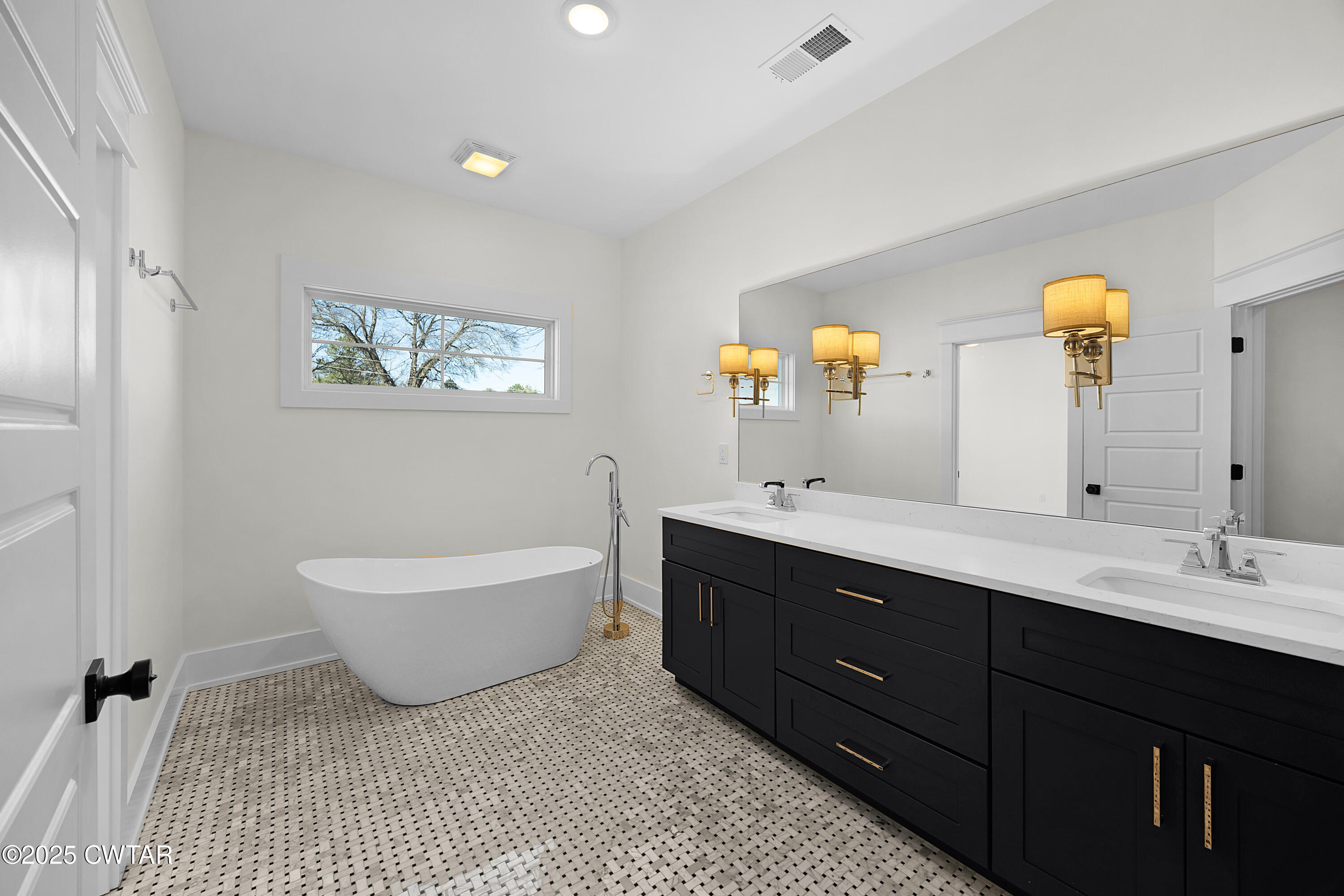 219 Clay Street Jackson, TN 38301 - Photo 19 of 25 a spacious bathroom with a double vanity sink and a mirror