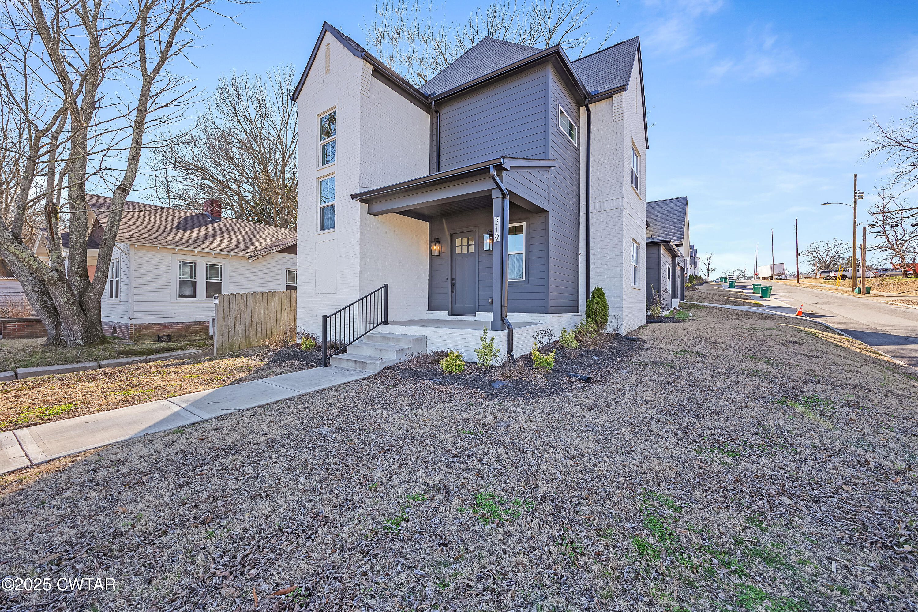 219 Clay Street Jackson, TN 38301 - Photo 25 of 25 a view of a house with a yard and the trees