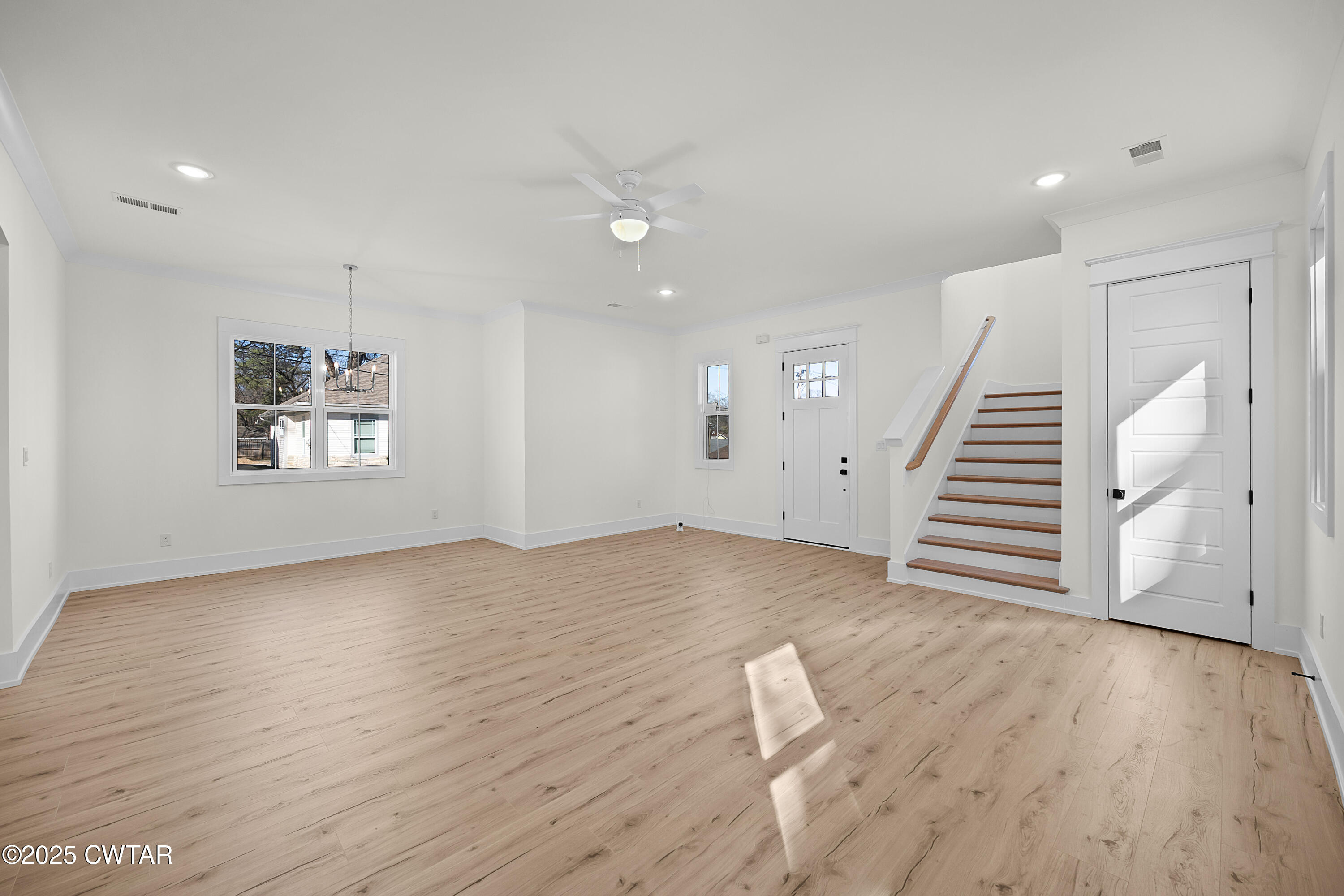 219 Clay Street Jackson, TN 38301 - Photo 4 of 25 an empty room with wooden floor and windows