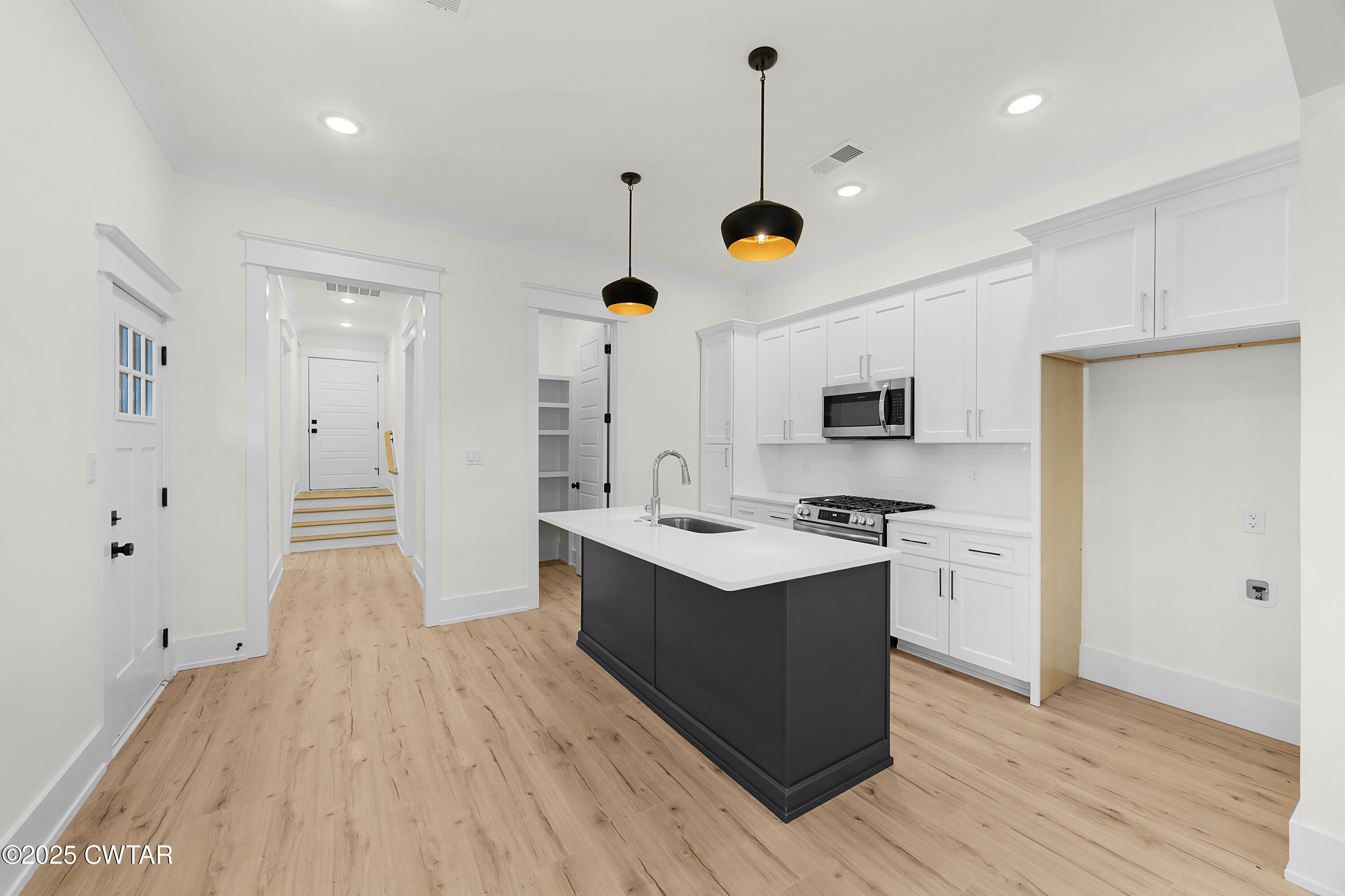 219 Clay Street Jackson, TN 38301 - Photo 6 of 25 a kitchen with stainless steel appliances kitchen island a sink and wooden floor