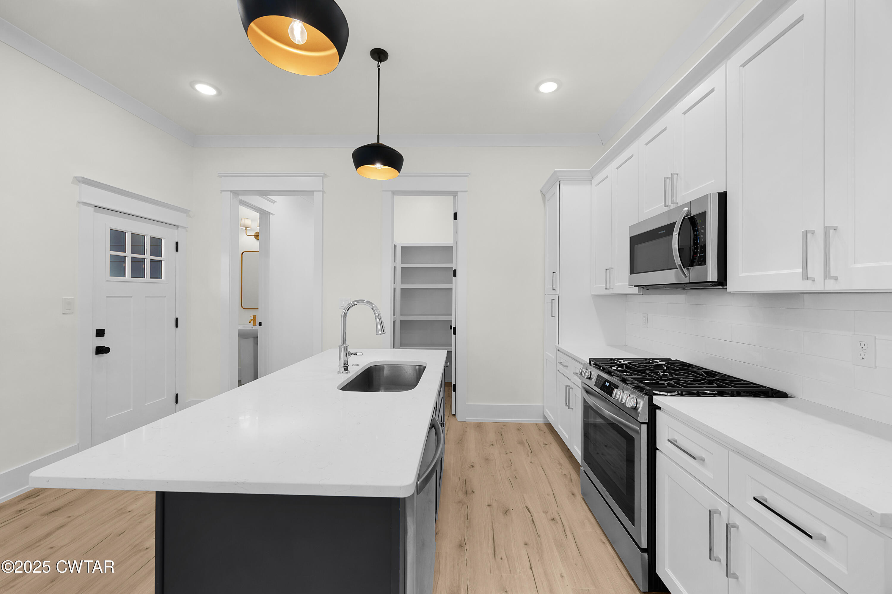 219 Clay Street Jackson, TN 38301 - Photo 7 of 25 a kitchen with granite countertop a sink stainless steel appliances and cabinets