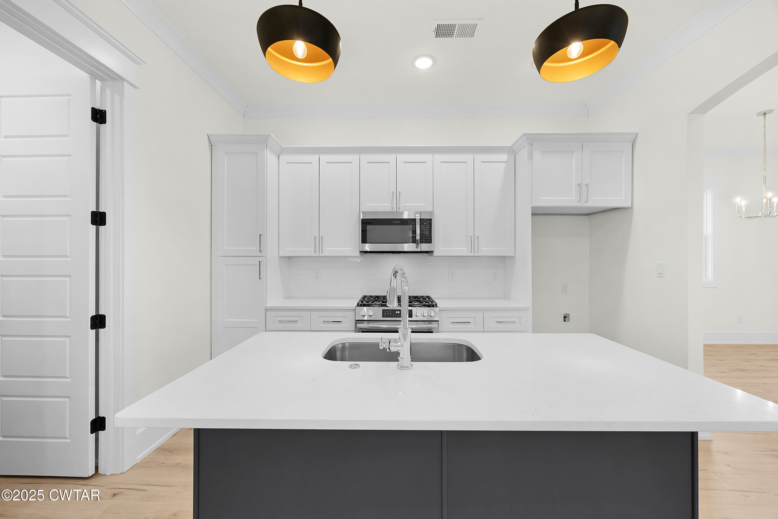 219 Clay Street Jackson, TN 38301 - Photo 8 of 25 a kitchen with a sink a microwave and cabinets