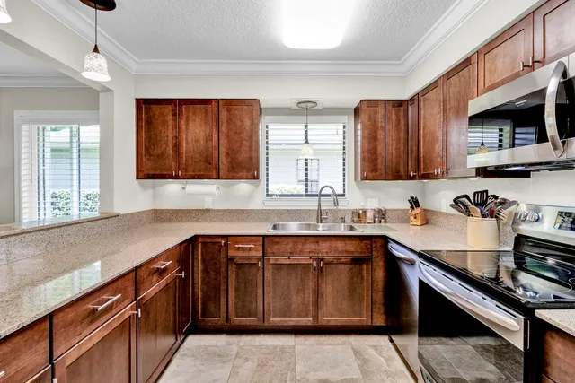 a kitchen with a sink stove top oven and cabinets