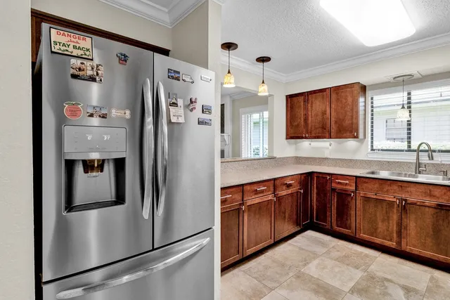 a kitchen with stainless steel appliances granite countertop a refrigerator and a sink