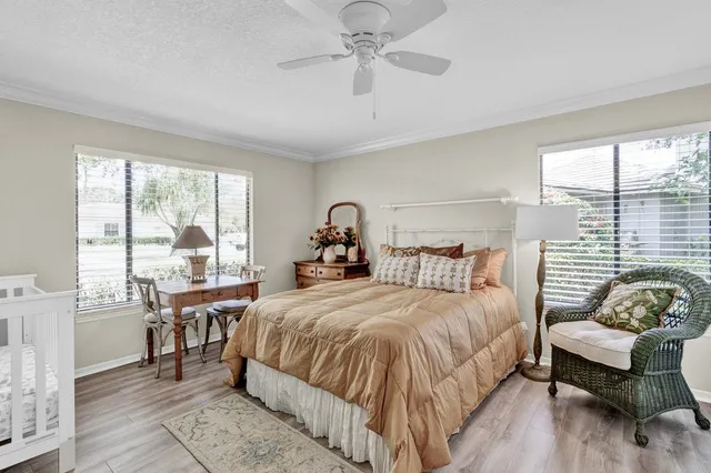 a bedroom with a bed and a large window