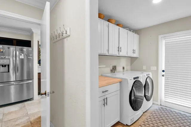 a kitchen with stainless steel appliances granite countertop a refrigerator and a stove
