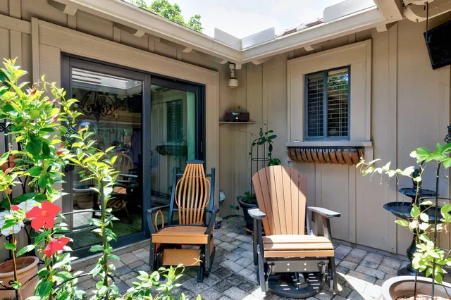 a front view of a house with outdoor seating
