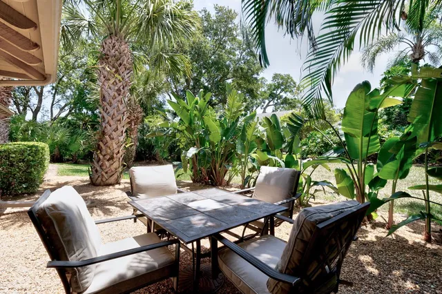 a view of a backyard with sitting area