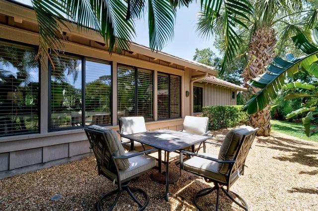 a view of a house with backyard and sitting area