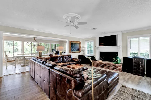 a living room with furniture fireplace and a window