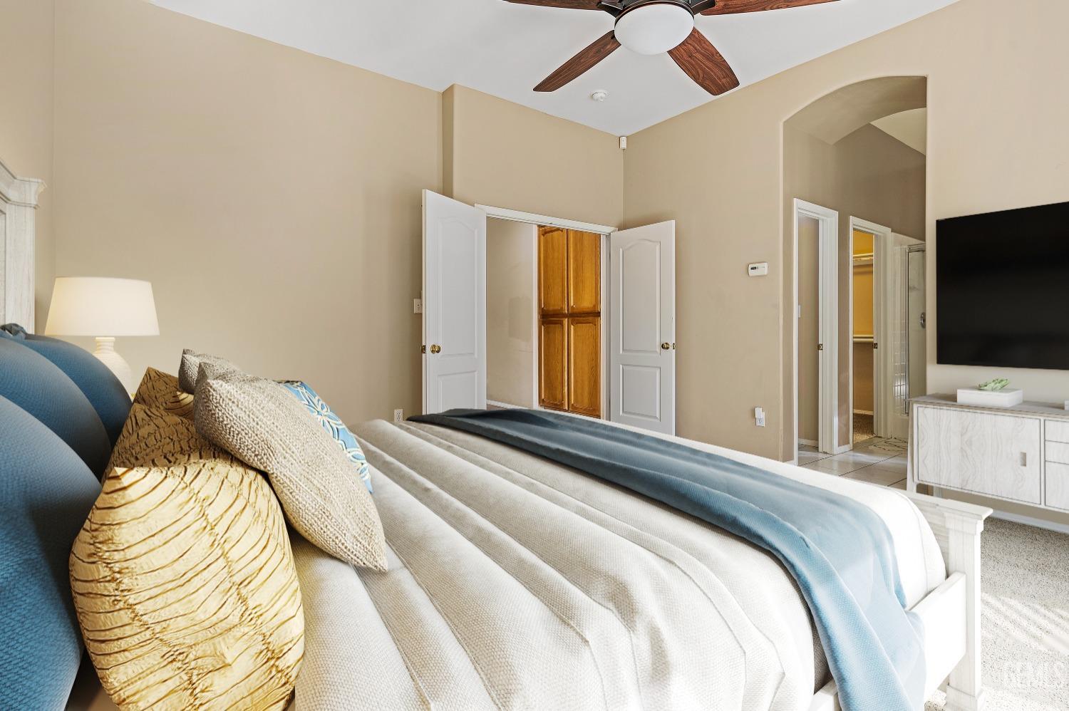 Undisclosed Address Bakersfield, CA 93306 - Photo 17 of 41 a bedroom with a bed and a flat screen tv