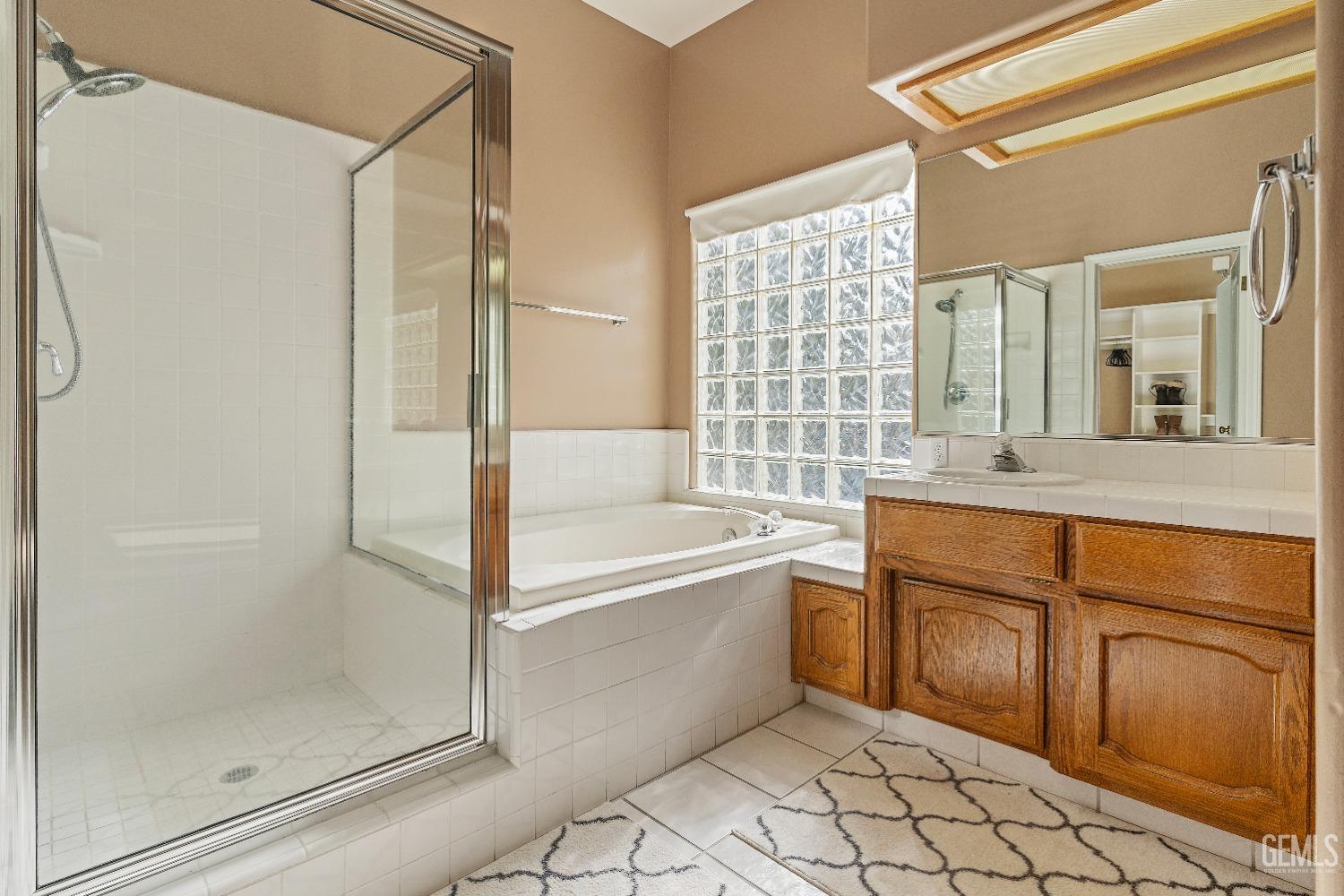 Undisclosed Address Bakersfield, CA 93306 - Photo 18 of 41 a bathroom with a tub shower sink and mirror