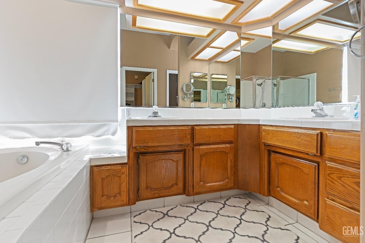 Undisclosed Address Bakersfield, CA 93306 - Photo 19 of 41 a view of a bathroom with sink and mirror