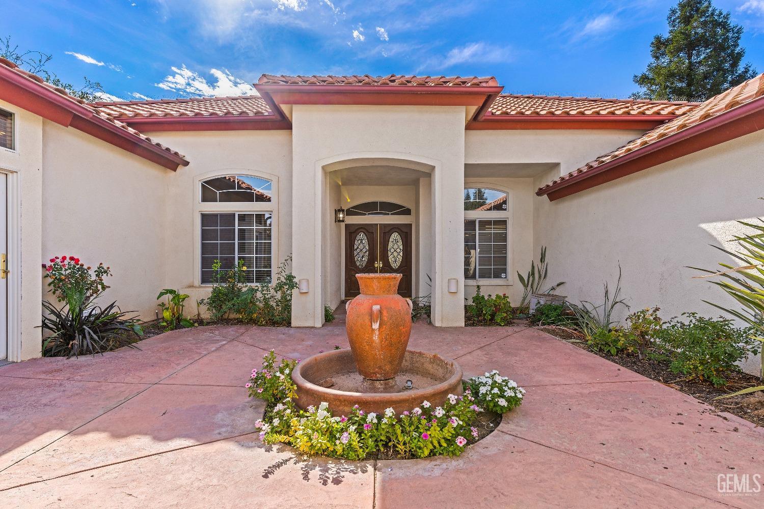 Undisclosed Address Bakersfield, CA 93306 - Photo 2 of 41 a front view of a house with garden