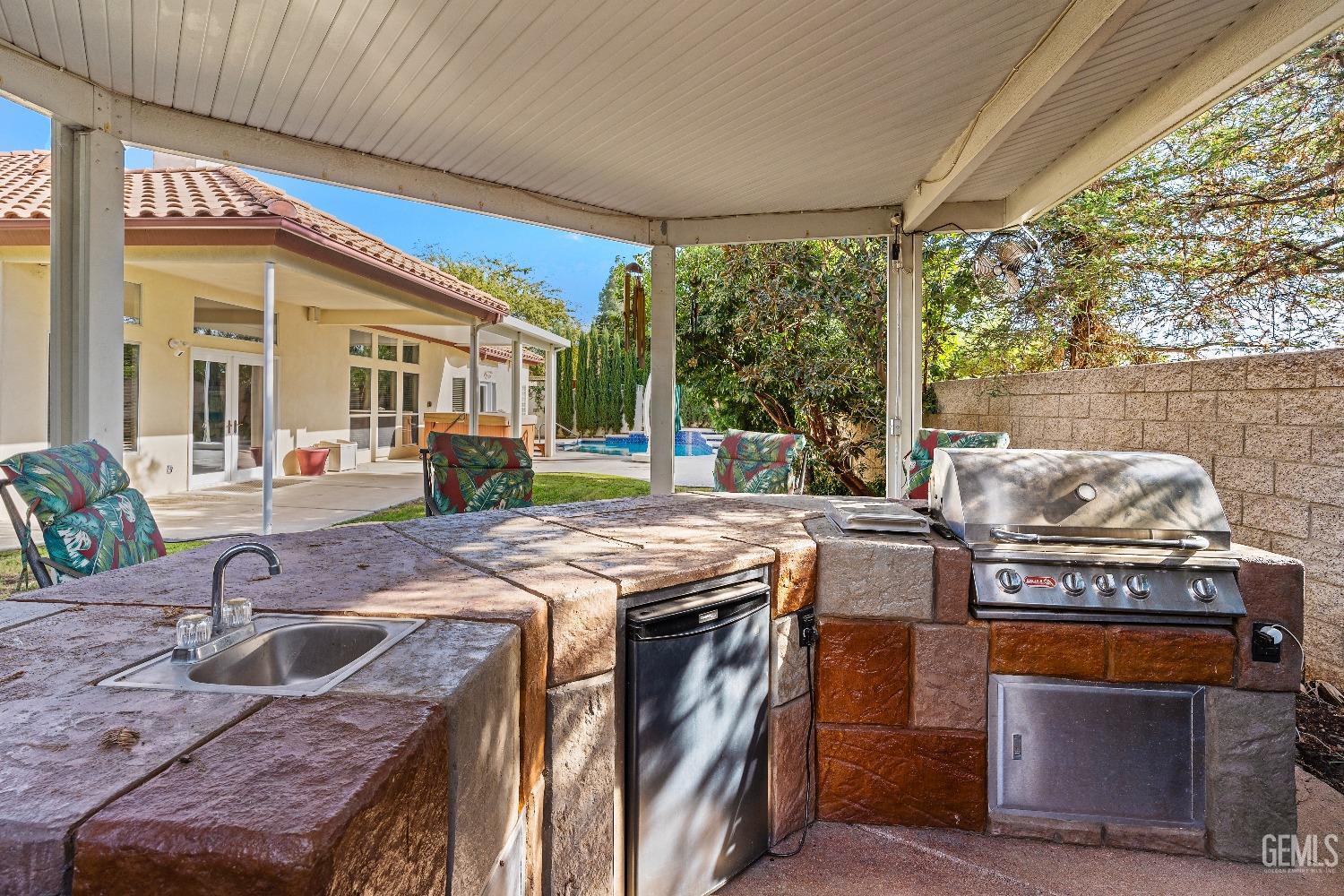 Undisclosed Address Bakersfield, CA 93306 - Photo 36 of 41 a kitchen with stainless steel appliances granite countertop a stove a sink and a microwave