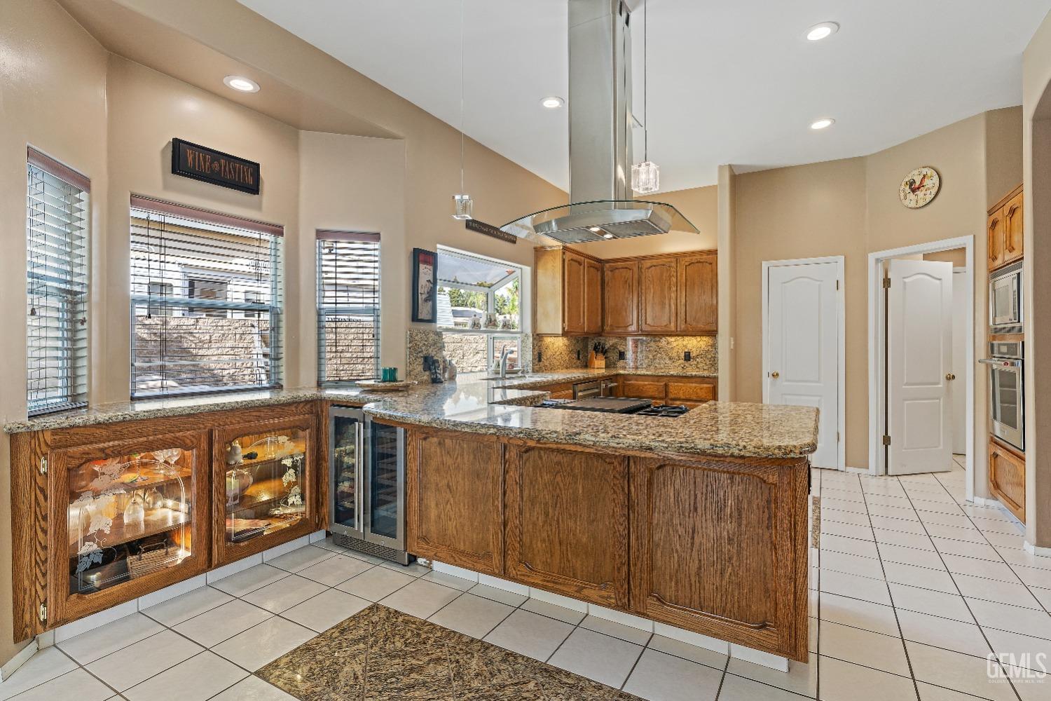 Undisclosed Address Bakersfield, CA 93306 - Photo 6 of 41 a large kitchen with stainless steel appliances granite countertop a refrigerator and a sink