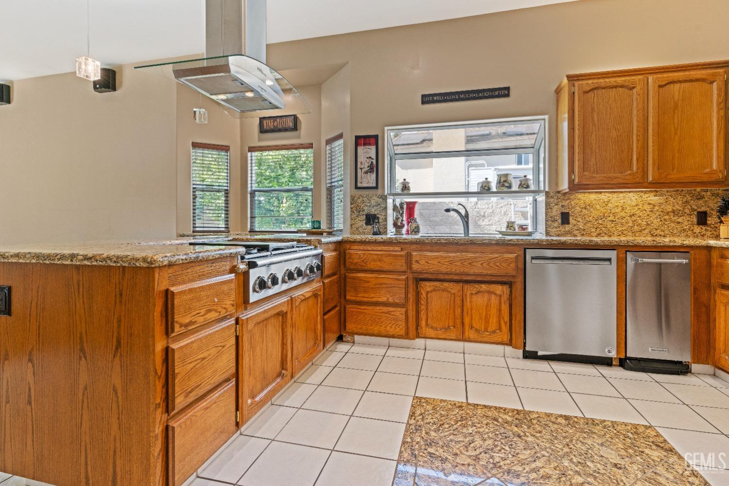 Undisclosed Address Bakersfield, CA 93306 - Photo 8 of 41 a kitchen with stainless steel appliances granite countertop a stove a sink and a microwave