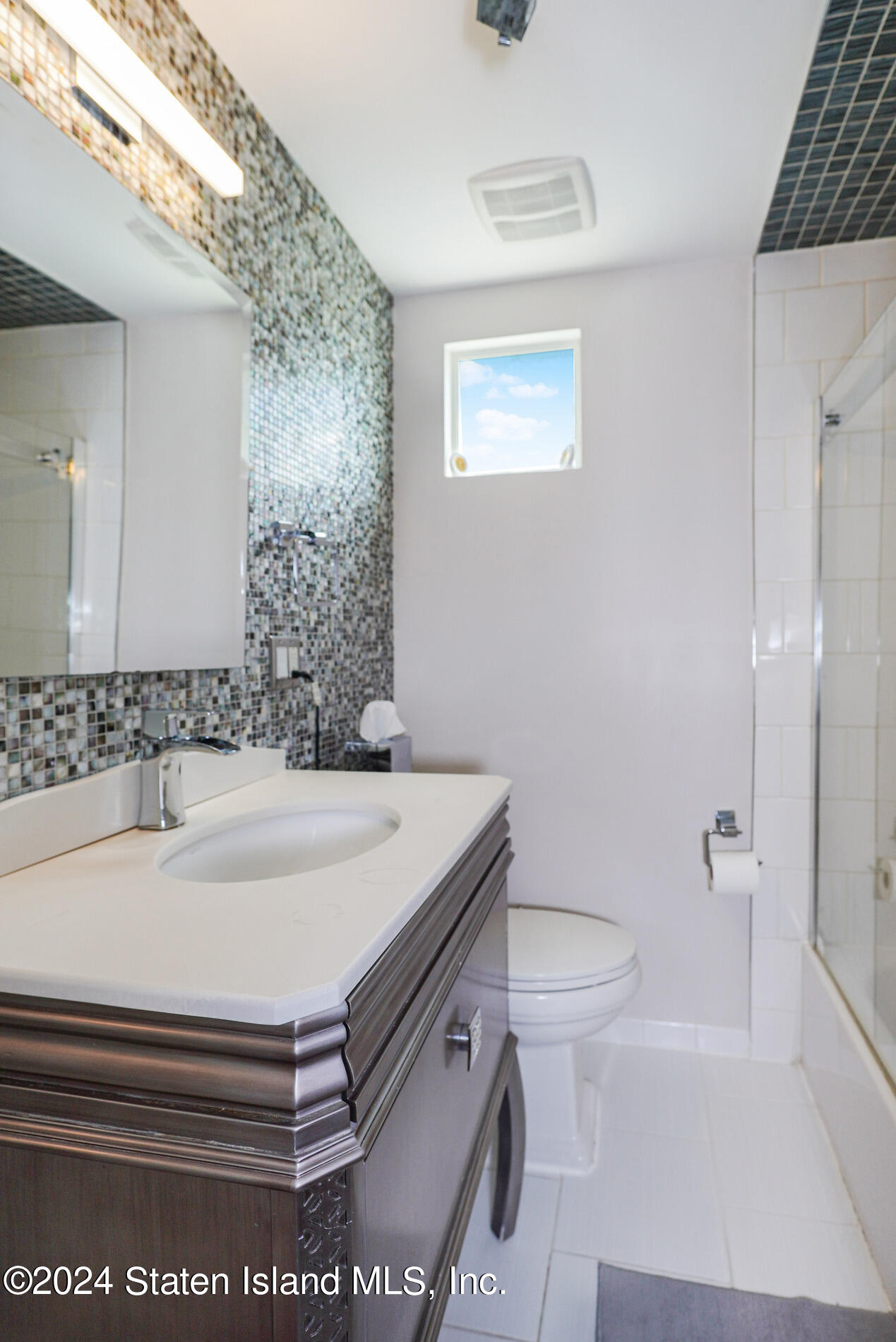 38 Milbank Road Staten Island, NY 10306 - Photo 13 of 30 a bathroom with a sink a toilet and shower