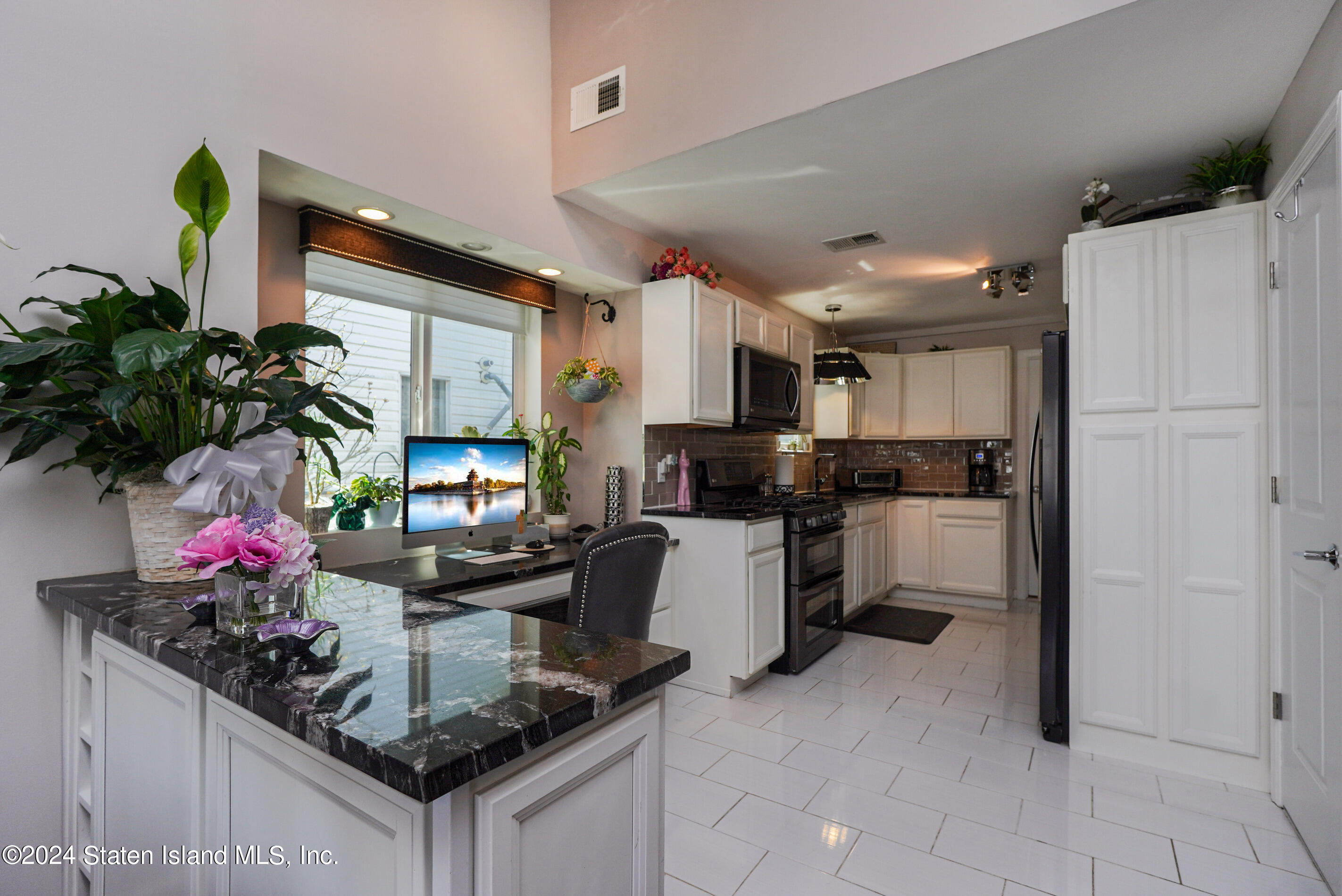 38 Milbank Road Staten Island, NY 10306 - Photo 2 of 30 a kitchen with counter top space cabinets and stainless steel appliances