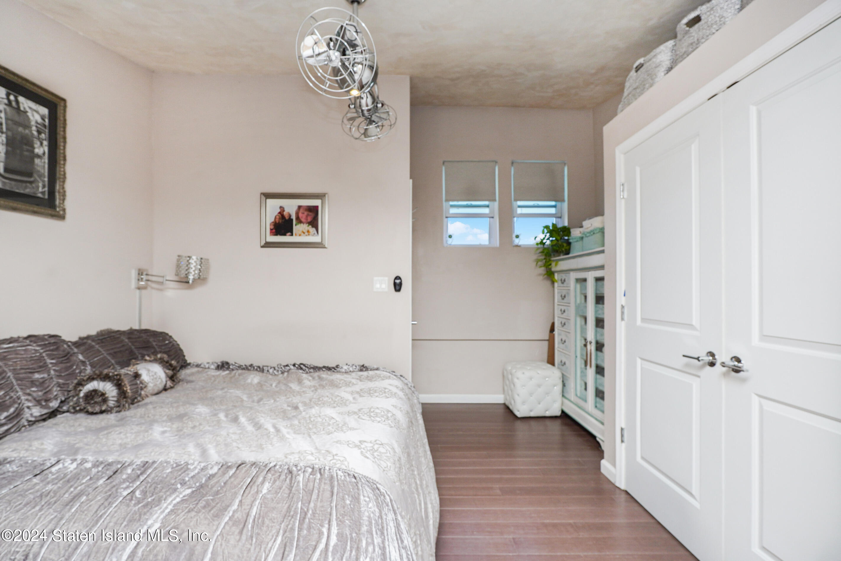 38 Milbank Road Staten Island, NY 10306 - Photo 21 of 30 a bedroom with a bed and a chandelier