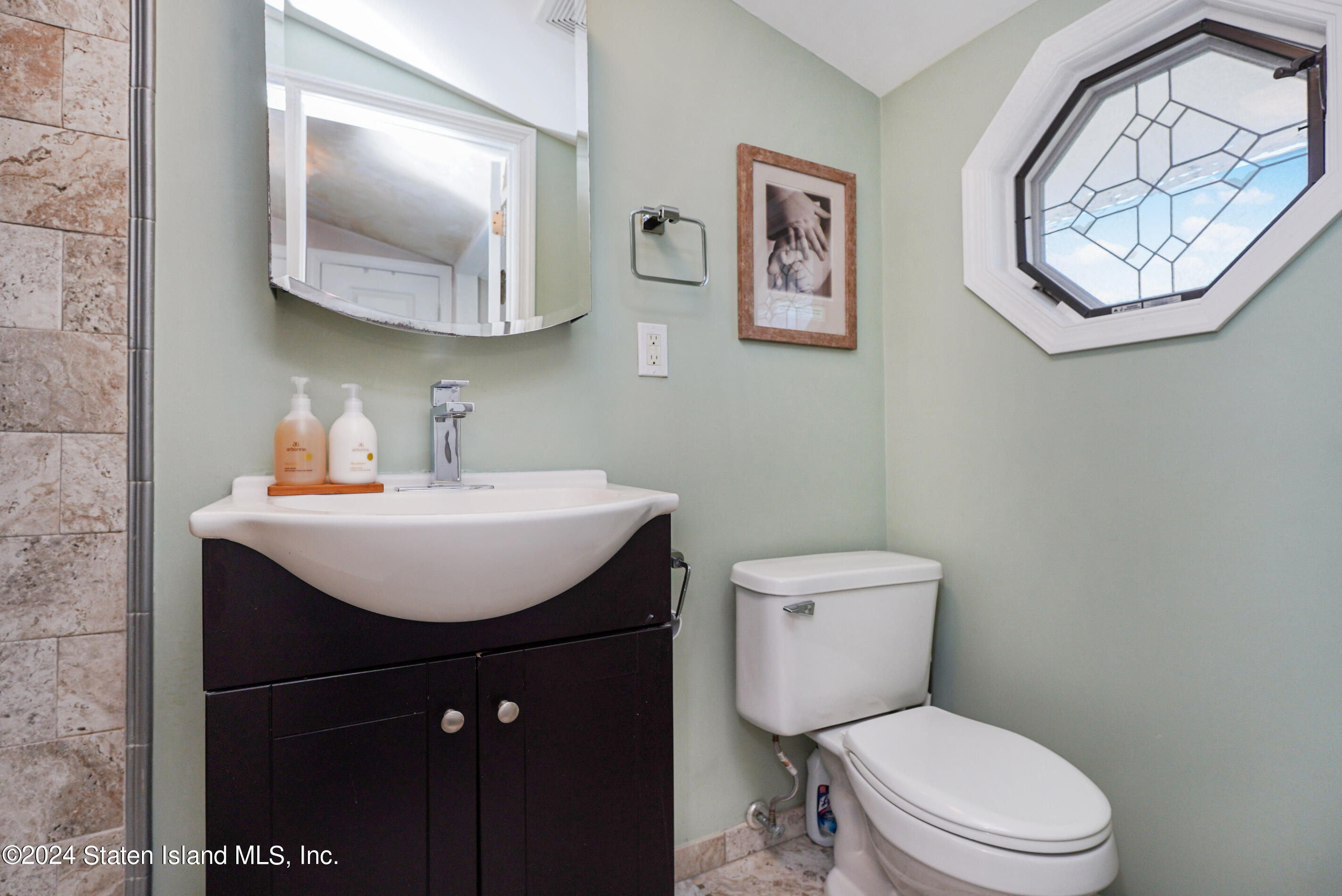 38 Milbank Road Staten Island, NY 10306 - Photo 23 of 30 a bathroom with a toilet a sink and mirror