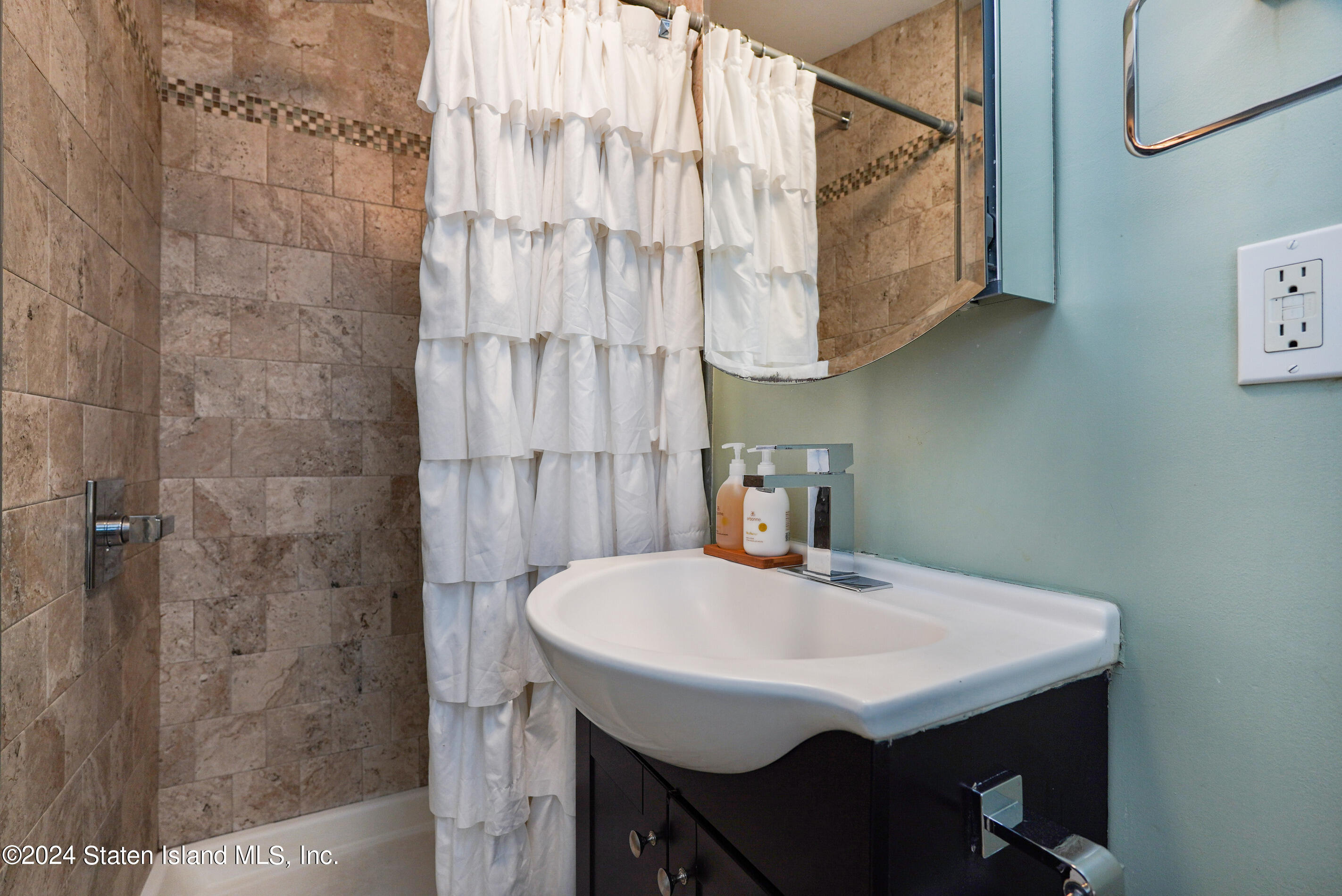 38 Milbank Road Staten Island, NY 10306 - Photo 25 of 30 a bathroom with a sink and a mirror