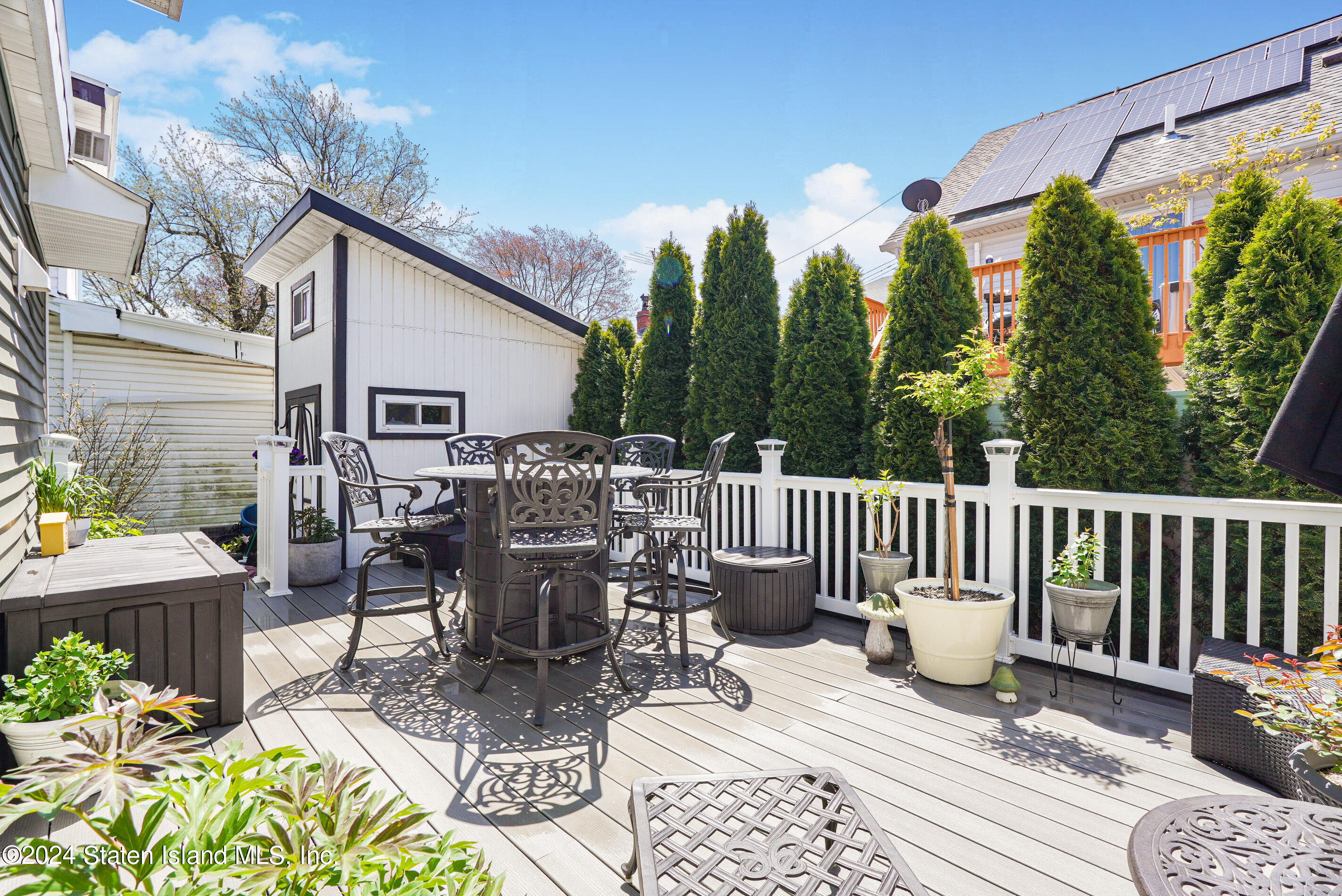 38 Milbank Road Staten Island, NY 10306 - Photo 26 of 30 a view of a patio with a dining table and chairs