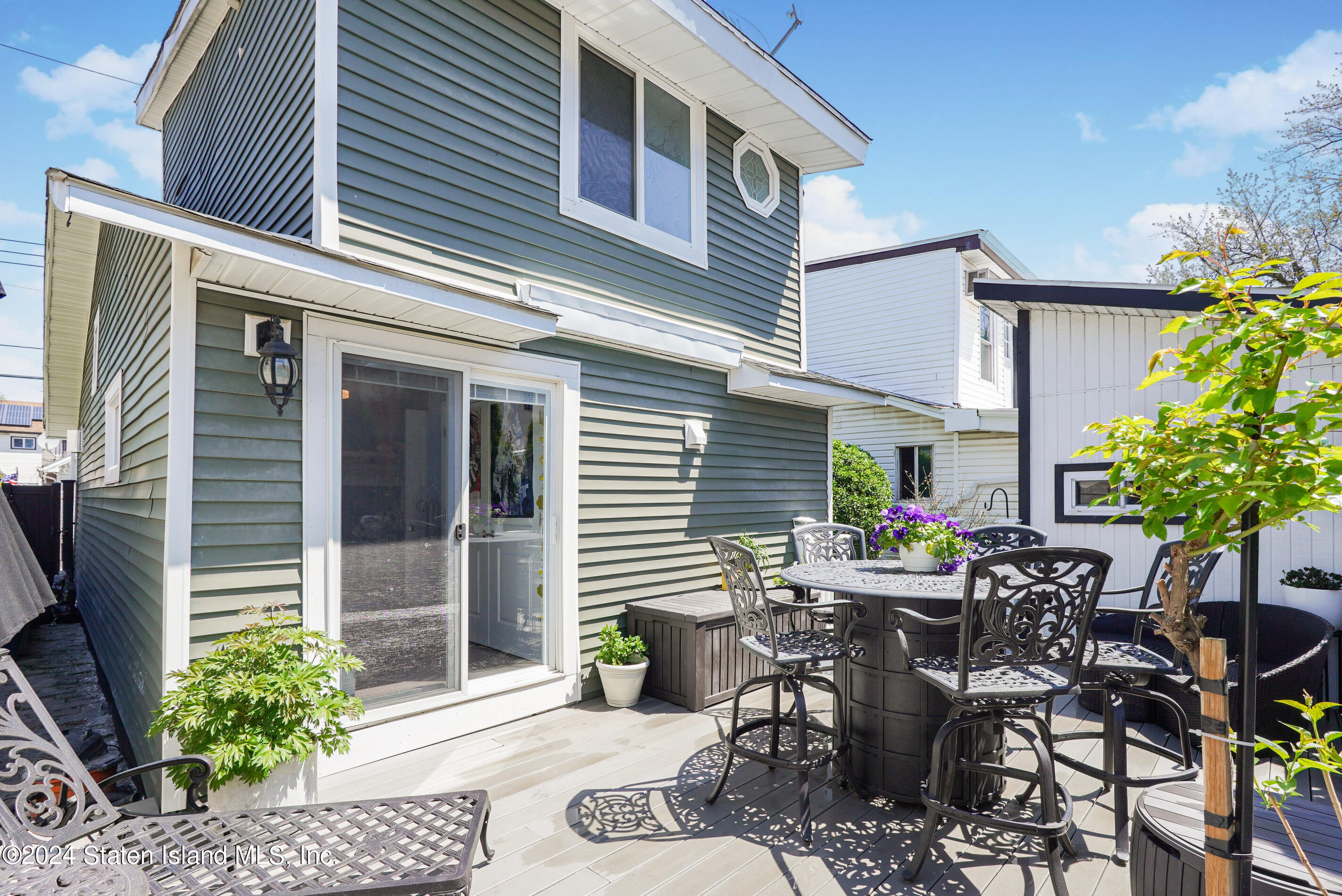 38 Milbank Road Staten Island, NY 10306 - Photo 27 of 30 a view of a patio with table and chairs and potted plants