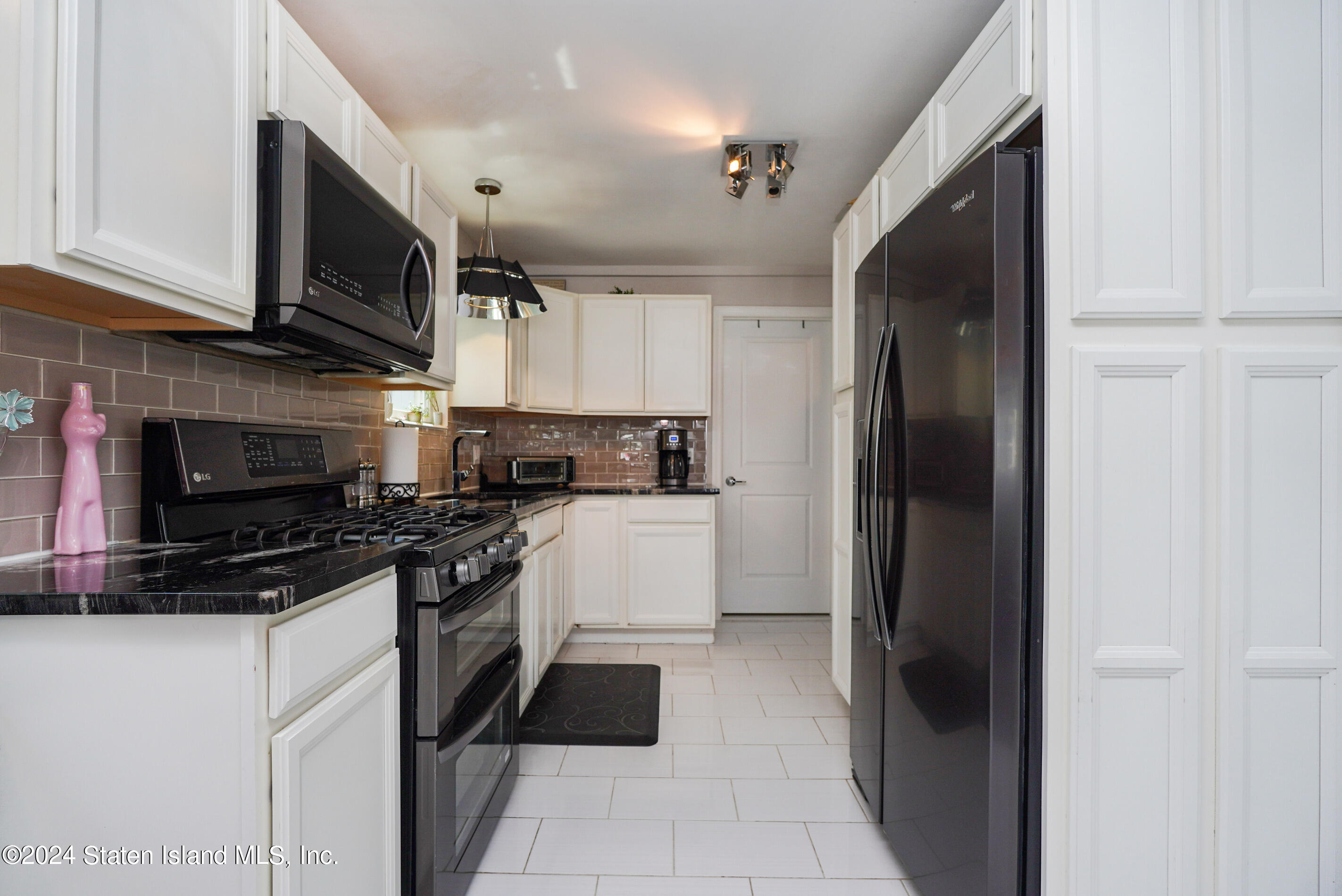 38 Milbank Road Staten Island, NY 10306 - Photo 3 of 30 a kitchen with stainless steel appliances granite countertop a refrigerator and a stove top oven