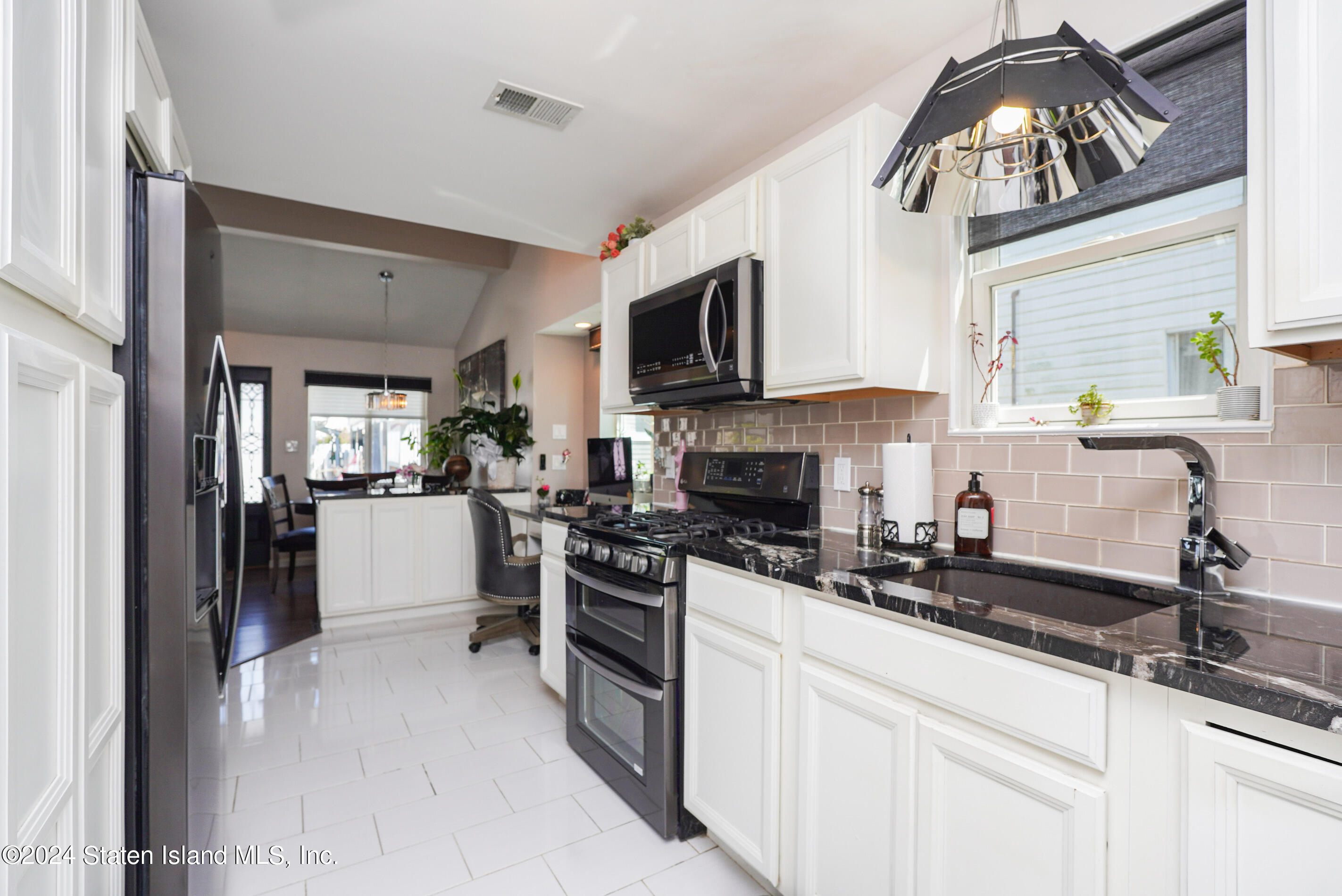 38 Milbank Road Staten Island, NY 10306 - Photo 5 of 30 a kitchen with stainless steel appliances granite countertop a sink a stove and cabinets