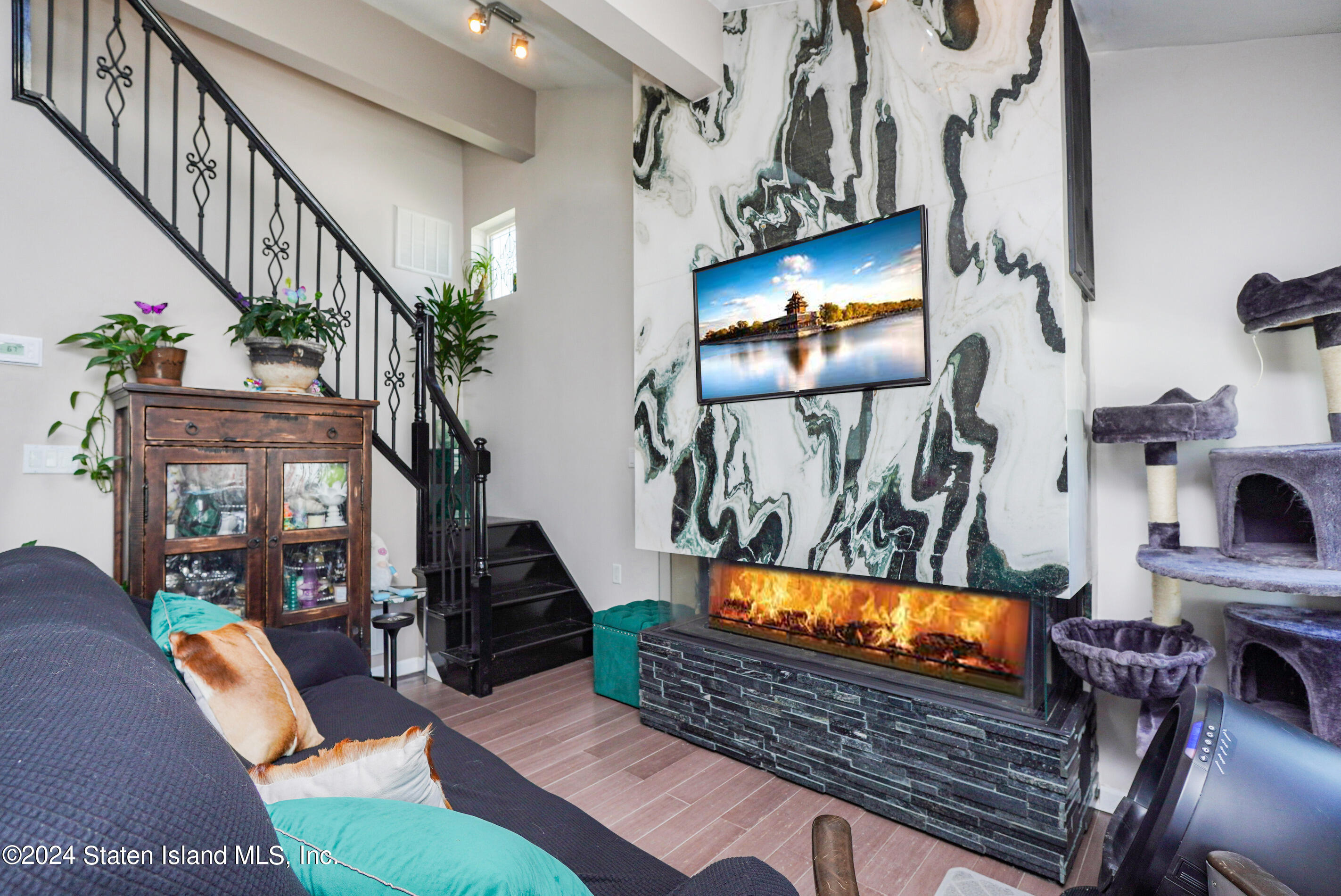 38 Milbank Road Staten Island, NY 10306 - Photo 10 of 30 a living room with furniture and a fireplace