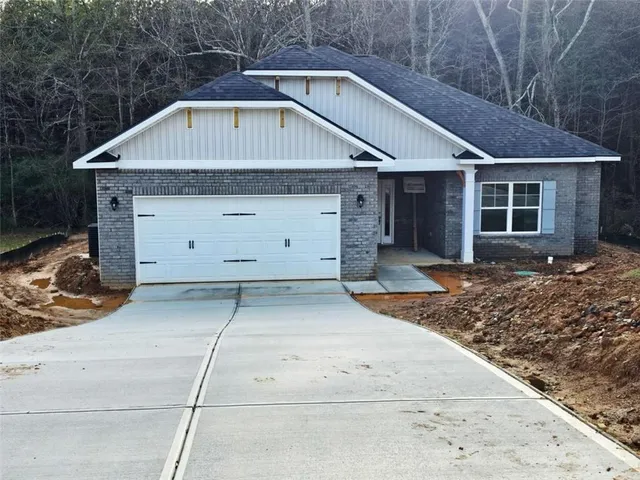 a front view of a house with garage