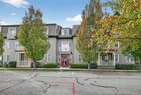 front view of a brick house with a yard