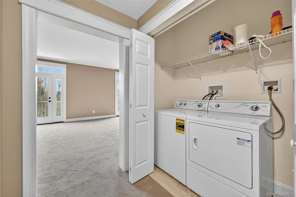 a utility room with cabinets washer and dryer