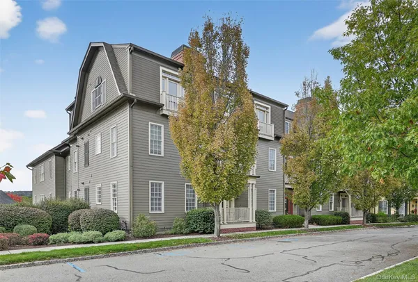 a front view of a residential houses with yard